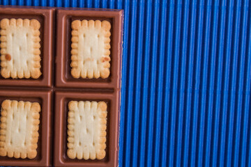 Close-up mixed chocolate bar with crunchy cookies.