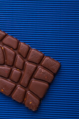 Close-up unusual milk chocolate bar with relief.