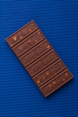 Vertical shot top view chocolate bar with hazelnut.