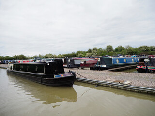 A line of narrowboats seen in a canal Marina