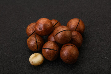 Brown macadamia nut heap over background