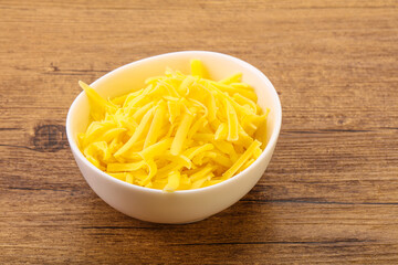 Shredded yellow cheese in the bowl