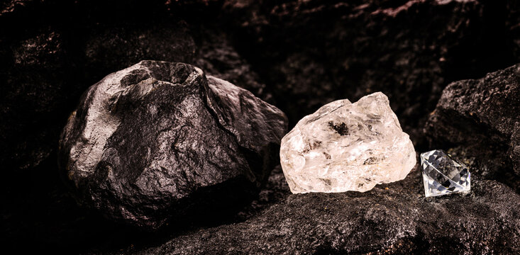 diamond mine with rough diamond stone, cut diamond and carbon or graphite ore, on kimberlite rocks, transformation into rare stone concept