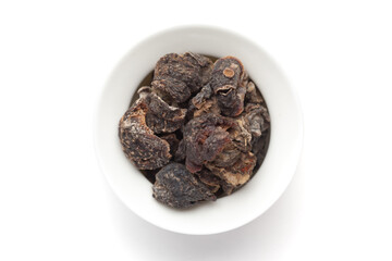 closeup of Organic Dried gooseberry or Amla (Ribes grossularia) on a ceramic white bowl.