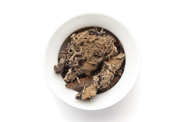Macro close-up of Organic  Kalpasi or Dagad phool or black stone flower or chhabila on white background. Pile of Indian Aromatic Spice. Top view