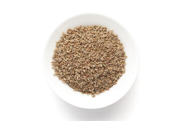 Macro close-up of Organic Ajwain seed (Trachyspermum ammi) or thymol seeds on white background. Pile of Indian Aromatic Spice. Top view