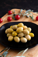Large green olives. Tasty green olives in the plate.