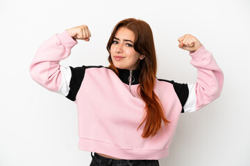 Young redhead woman isolated on white background doing strong gesture