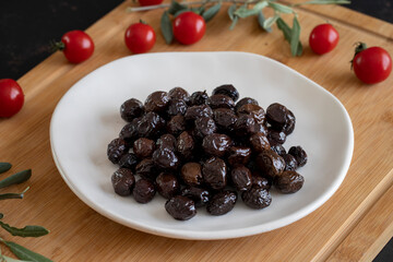 Organic black olives. Delicious black olives on the plate.