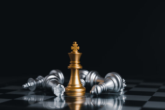 The gold horse, knight chess piece standing with falling silver pawn chess  pieces on chessboard on white background with copy space. Leadership,  winner, competition, and business strategy concept. Photos