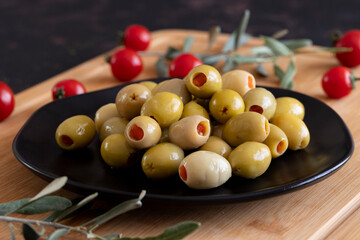 Green olives stuffed with peppers. Delicious green olives on the plate.