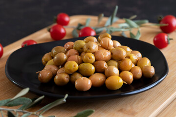 Organic green village olives. Delicious green olives on the plate.