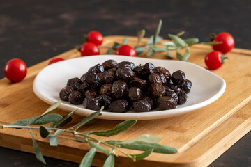 Organic black olives. Delicious black olives on the plate.