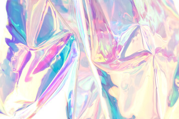Fototapeta na wymiar Defocused iridescent holographic background. Blurred colorful texture of wrinkled foil.