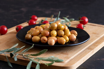 Delicious green olives. Tasty green olives in the plate.
