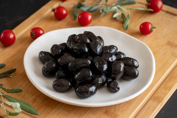 Kalamata olives. Tasty black kalamata olives in the plate.