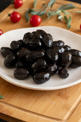 Kalamata olives. Tasty black kalamata olives in the plate.
