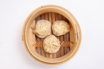 Xiao long bao dim sum dumpling chicken prawn fish seafood vegetable in bamboo steamer on white...