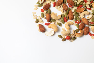 mixed organic cereal and grain seed pile on white background. healthy eating concept. pumpkin, sunflower seeds and legumes.