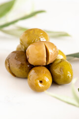 Close-up green kalamata olives. Organic olives on a marble floor