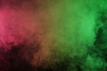 Artificial smoke in red-green light on black background