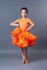 Kids sport dancing, kid girl in orange sport dress posing