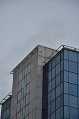 Looking up at modern buildings with a cloudy sky background. Taken in Manchester England. 