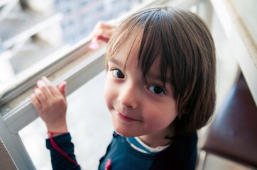 Little girl looking out the window