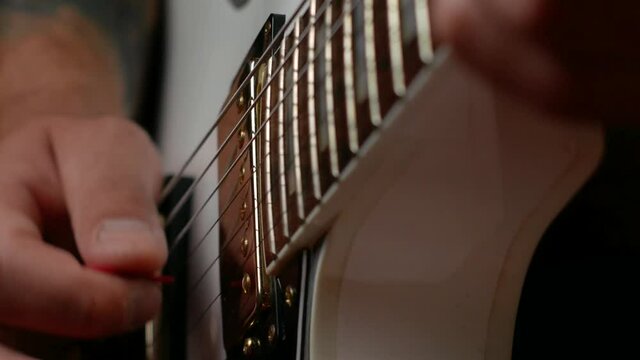 Guitarist Plays Dynamic Solo On White Guitar