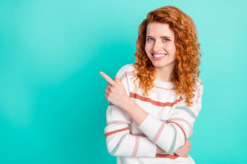 Photo portrait curly woman smiling pointing finger empty space choosing isolated bright turquoise...