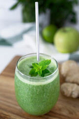 Fresh green fruit and vegetable smoothie. Detox smoothie with spinach, celery, mint, green apple and ginger. Healthy diet. Vegetarian and vegan diet.