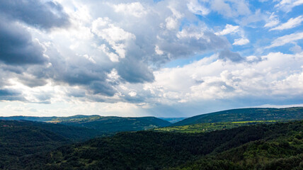 Drone footage over the mountains clouds before rain