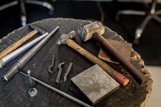 Close up of diverse jeweller tools lying on table in workshop