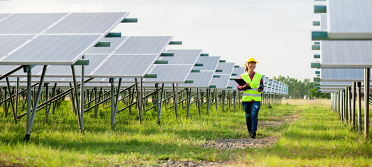 A young female solar cell engineer is working hard. Working in alternative energy Solar energy