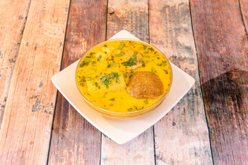 glass bowl filled to overflowing with recipe for Peruvian bouillon