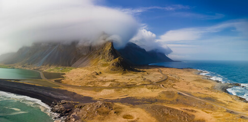Panoramic view of cloud cover mountains in Iceland eastern shore line