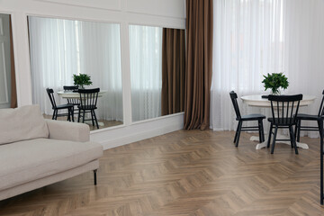 Modern room with parquet flooring and stylish furniture