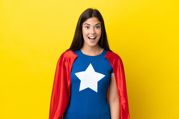 Super Hero Brazilian woman isolated on yellow background with surprise facial expression