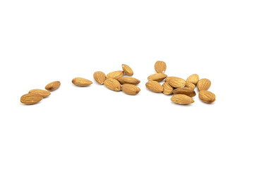 Almond nuts isolated on white background. Heap of scattered almonds