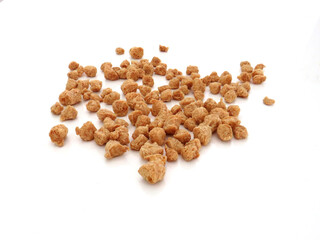 Bulk coarse textured soybeans on white background. Legume and vegetarian food. Close up of vegetable protein from soy flour. TVP.