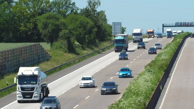 Weilbach, Germany - June 14, 2021: Large trucks and dense traffic on autobahn A3 near Wiesbadener Kreuz. The Bundesautobahn 3 (abbreviated as BAB 3 or A 3) is a highway in Germany that links the borde