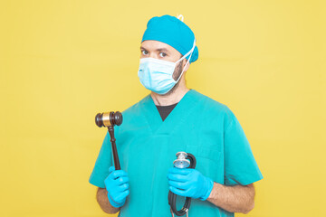 young doctor-surgeon dressed in green on yellow background.