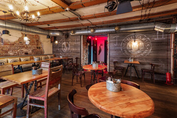 Hip bar cozy interior with wooden furniture.