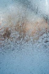 Fototapeta na wymiar blue frost pattern on a window glass. winter background. Macro closeup wallpaper. Banner hoarfrost background template