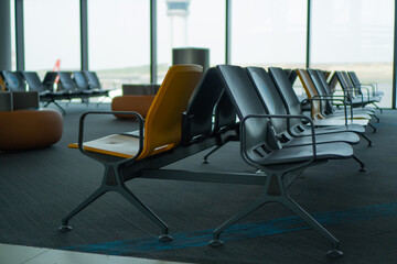 Empty chairs in the airport. Empty seats in the departure lounge at the airport. Empty airport terminal waiting area
