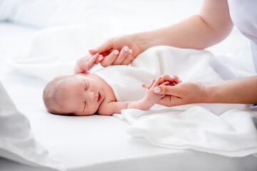 Newborn baby and mother hand