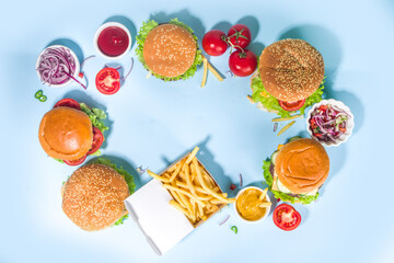 Various burgers set on blue background