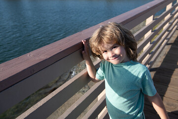 Leisure break. Happy boy child stand at promenade railing. Leisure time. Summer vacation