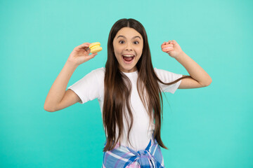 Fototapeta premium amazed child hold french macaron or macaroon cookies, sweet tooth