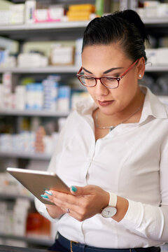 Pharmacy manager working on an electronic tablet